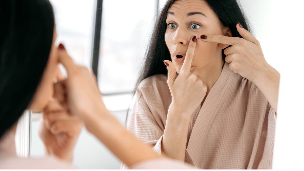 Woman examining acne or facial hair concerns